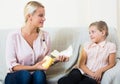 Mother with daughter discussing menstruation and sanitary products Royalty Free Stock Photo