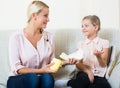 Mother with daughter discussing menstruation and sanitary products Royalty Free Stock Photo