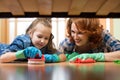 Mother and daughter do the cleaning in the house. Happy woman and little child girl wiped the floor. Royalty Free Stock Photo