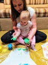 Mother and daughter do handprints with green paint Royalty Free Stock Photo