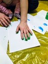 Mother and daughter do handprints with green paint Royalty Free Stock Photo