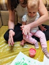 Mother and daughter do handprints with red paint Royalty Free Stock Photo