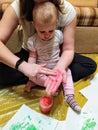 Mother and daughter do handprints with red paint Royalty Free Stock Photo