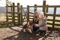 Mother and daughter with dog in the countryside, full length Royalty Free Stock Photo