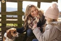 Mother, daughter and dog by a fence in the country, close up Royalty Free Stock Photo