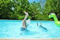 Mother and daughter doing handstands in the pool Royalty Free Stock Photo