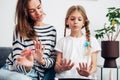 Mother and daughter doing manicure at home, painting nails with nail polish Royalty Free Stock Photo