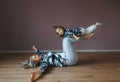 Mother and daughter doing yoga exercise. Little girl balancing on legs of mother Royalty Free Stock Photo