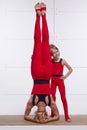 Mother and daughter doing yoga exercise, fitness, gym wearing the same comfortable tracksuits, family sports paired woman