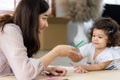 Mother and daughter drawing and coloring with colored pencils lying down on the floor. Happy family moment in the house.Art Royalty Free Stock Photo