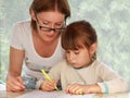 Mother and daughter drawing together