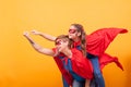 Mother and daughter dressed like superheros flying off save the world from villans Royalty Free Stock Photo