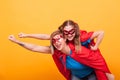 Mother and daughter dressed like superheros flying off to save the world from villans Royalty Free Stock Photo