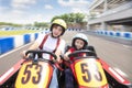 Mother and daughter driving go kart on the track Royalty Free Stock Photo