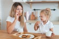 Mother and daughter eating cake and drinking tea. Happiness Cooking Activity Concept Royalty Free Stock Photo