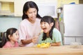 Mother and daughter eating fruits