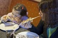 Mother and daughter eating pizza in restaurant