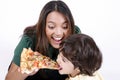 Mother and daughter eating pizza slice