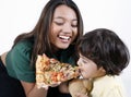 Mother and daughter eating pizza slice