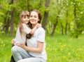 Mother and daughter embrace in the park