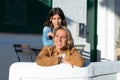 Mother and daughter embraced in sunset in a mediterranean village with white walls