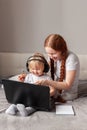 Mother and daughter enjoy laptop, happy family, online homeschooling Royalty Free Stock Photo