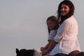 Mother and daughter enjoy riding horses together by the sea. Selective focus Royalty Free Stock Photo