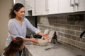 Mother and daughter enjoying spending time in the kitchen while cooking together. African American woman and cute little girl