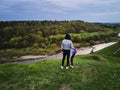 Mother and daughter enjoys the view on the coast Sluch river