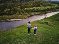 Mother and daughter enjoys the view on the coast Sluch river