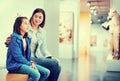 Mother and daughter exploring antique statues