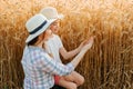 mother and daughter family of farmers touch the ears with their hands