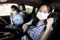 Mother and daughter fastening seat belt,woman sit in a car put on her seat belt for driving safety,child girl wearing a protective