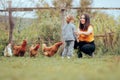 Mother and Daughter Feeding the Hens Enjoying Outdoor Activity Royalty Free Stock Photo