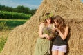 mother and daughter in a field near the straw stack Royalty Free Stock Photo