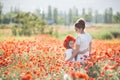 Beautiful mother and her daughter playing in spring flower field Royalty Free Stock Photo