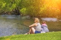 Mother and daughter fishing in the lake, in the pond