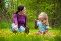 Mother and daughter with flowers outdoor