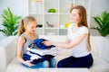 Mother and daughter folding laundry