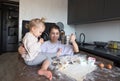 a happy mother and a girl daughter cook cookies and have fun in the kitchen. Homemade food and a little helper. Royalty Free Stock Photo