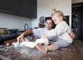 a happy mother and a girl daughter cook cookies and have fun in the kitchen. Homemade food and a little helper. Royalty Free Stock Photo