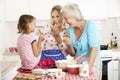 Mother,Daughter And Grandmother Baking In Kitchen