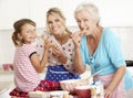 Mother,Daughter And Grandmother Baking In Kitchen