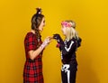 Mother and daughter in halloween costume frightening each other