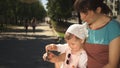 Mother and daughter happily spend time together playing with a fidgety spinner.