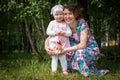 Mother and daughter have fun in the park and apple tree with white flowers Royalty Free Stock Photo