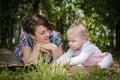 Mother and daughter have fun in the park and apple tree with white flowers Royalty Free Stock Photo