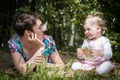 Mother and daughter have fun in the park and apple tree with white flowers Royalty Free Stock Photo