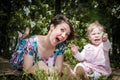 Mother and daughter have fun in the park and apple tree with white flowers Royalty Free Stock Photo