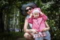 Mother and daughter have fun in the park and apple tree with white flowers Royalty Free Stock Photo